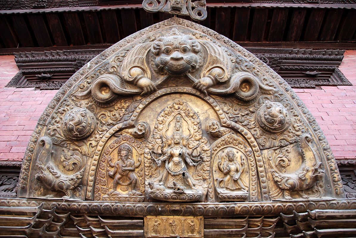 Kathmandu Patan Durbar Square 17 Gilded Torana With Ganesh, Shiva, Parvati and Kirtimukha Face Of Glory At The Top Above Patan Museum Golden Gate Sun Dhoka Entrance 